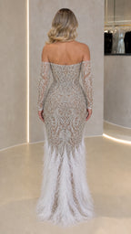 Back view of model in silver embellished long sleeve gown with floor-length feather trim