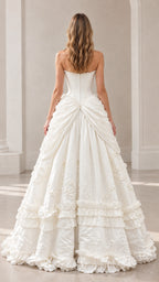 Back view of model in ivory strapless gown showing low back and tiered ruffles