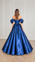 Back view of woman wearing royal blue satin corset maxi ball gown