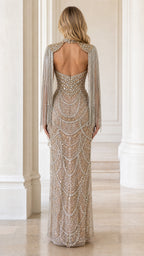 Back view of champagne embellished evening gown showing open back detail and capelet drape