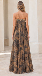 Back view of model showcasing tan floral strapless maxi dress