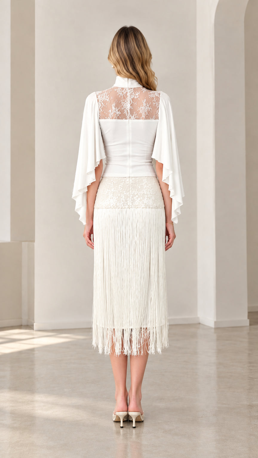 Back view of model showing sheer lace back and cape sleeves in white