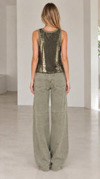 Back full-length view of model in olive green sequin scoop tank top