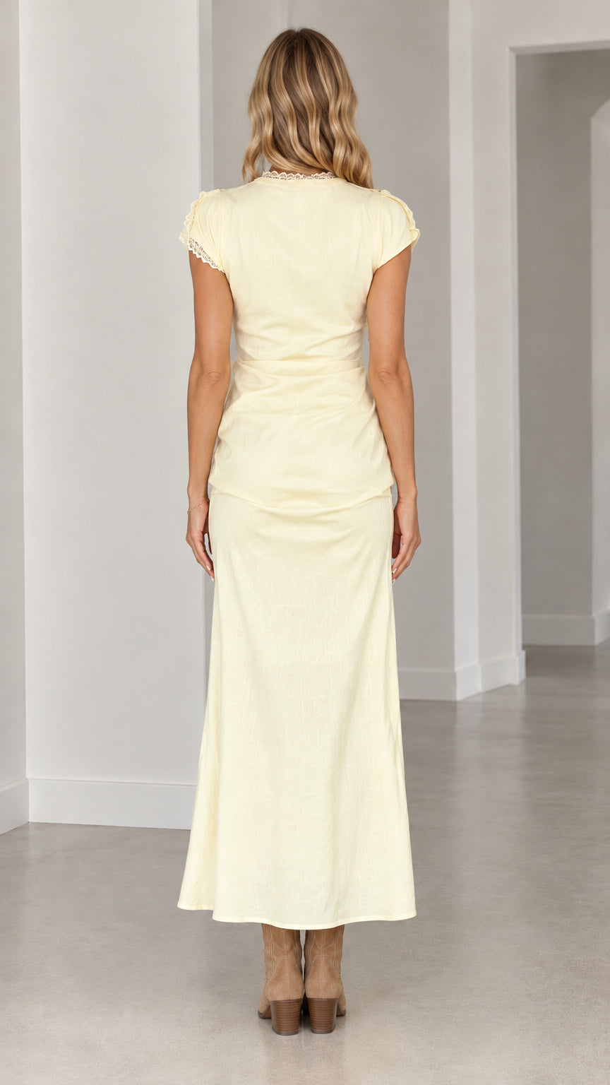 Back view of woman wearing butter yellow ruched maxi dress