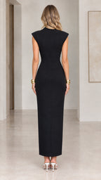 Back view of model showing clean silhouette of black cap sleeve maxi dress with back zipper