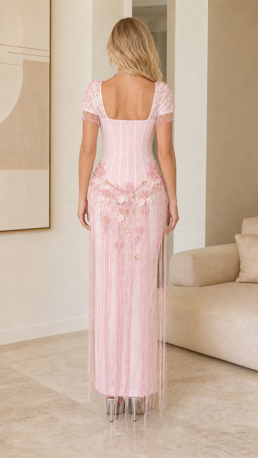 Back view of model showing square back and silhouette of Light Pink fringe dress