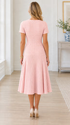 Back full-length view of model wearing blush pink tweed midi dress with back zipper