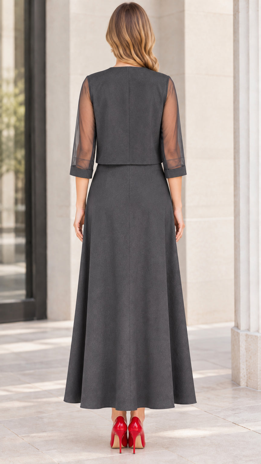Back view of charcoal grey formal dress set showing cropped jacket and sheer sleeves