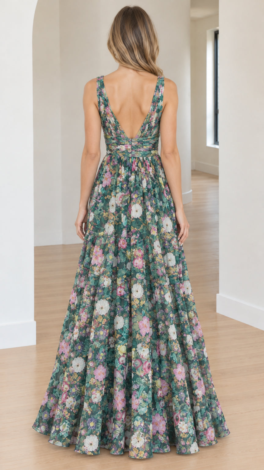 Back view of model showcasing the deep V-back cut on a green floral maxi dress