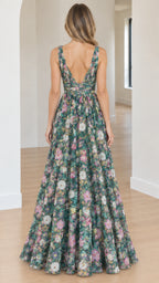 Back view of model showcasing the deep V-back cut on a green floral maxi dress
