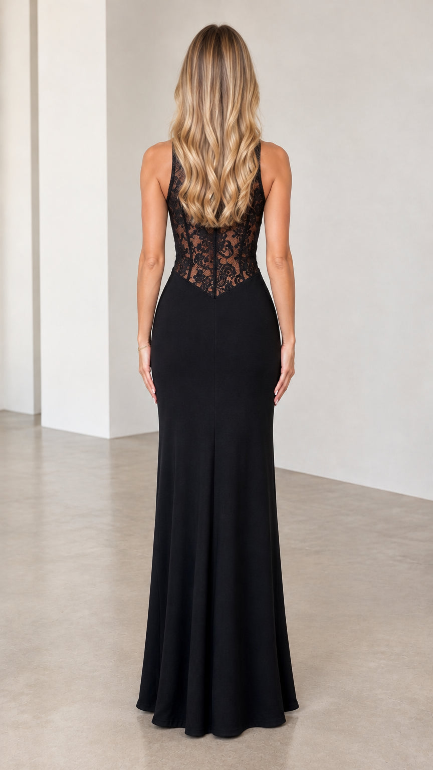 Back view of model in black halter maxi dress with sheer lace bodice details