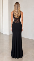 Back view of model in black halter maxi dress with sheer lace bodice details