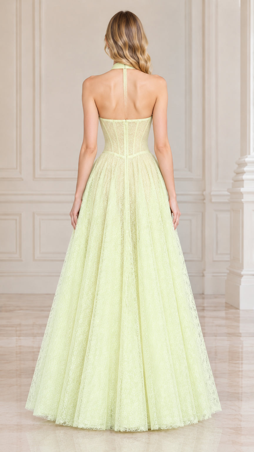 Back view of model wearing light yellow open back halter lace gown