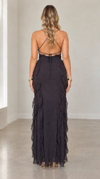 Back view of black maxi dress highlighting crisscross lace-up open back