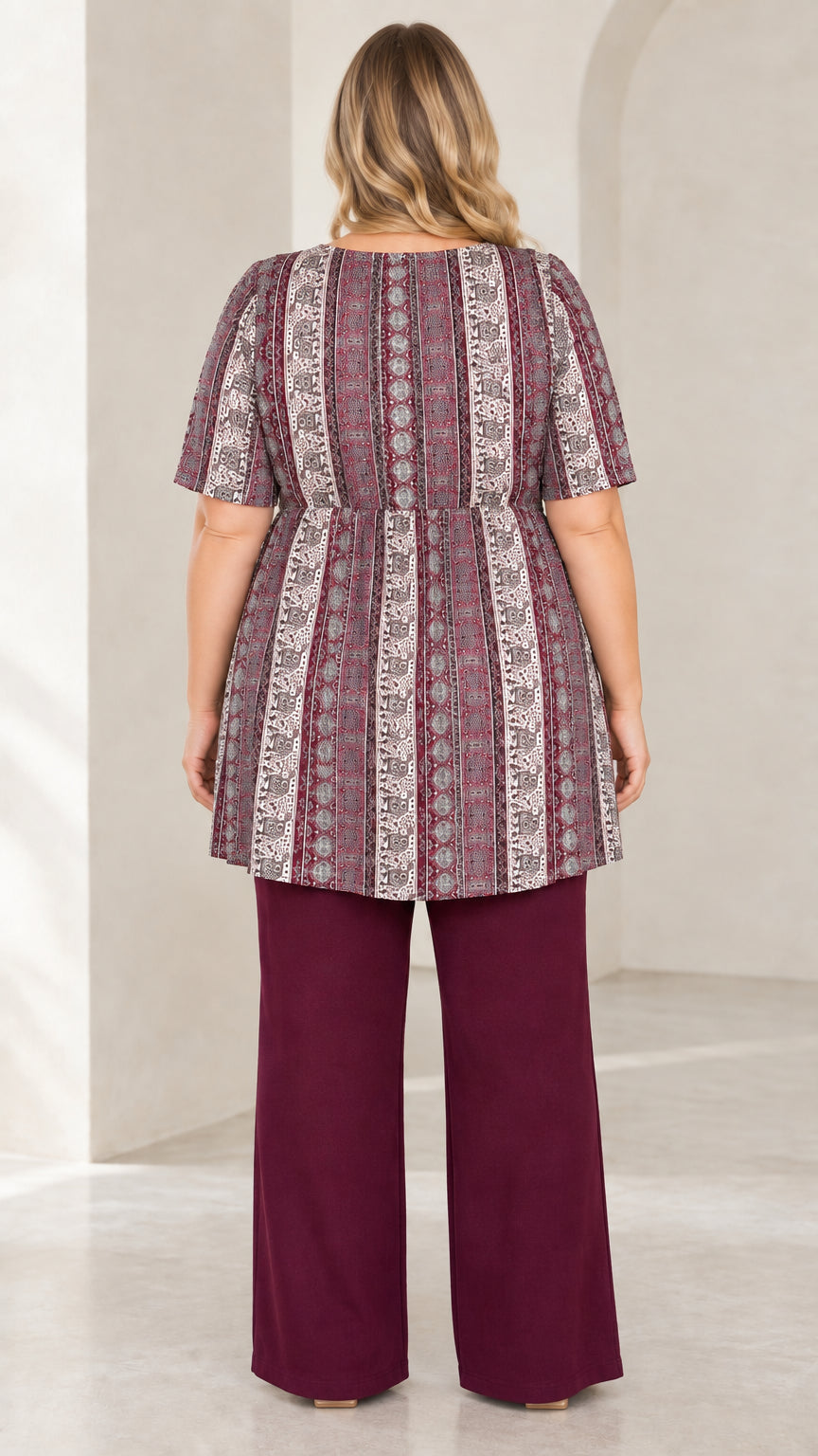 Back view of Burgundy short sleeve empire tunic top and solid wide leg trousers