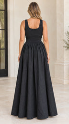Back view of model wearing black scoop neck smocked maxi dress