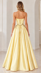 Rear view of model showing lace-up corset back of pastel yellow formal evening dress