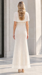 Back view of model wearing the Ivory embellished capelet maxi dress
