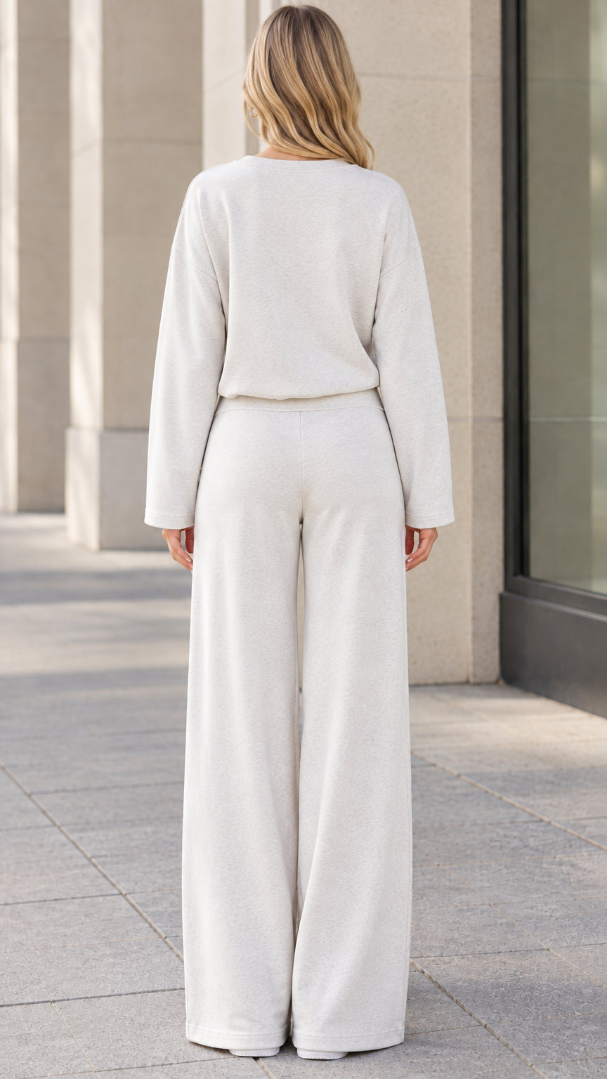 Back view of woman wearing beige matching pullover and wide leg trousers set