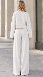 Back view of woman wearing beige matching pullover and wide leg trousers set