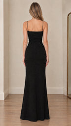 Back full-length view of black spaghetti strap evening gown showing fitted silhouette