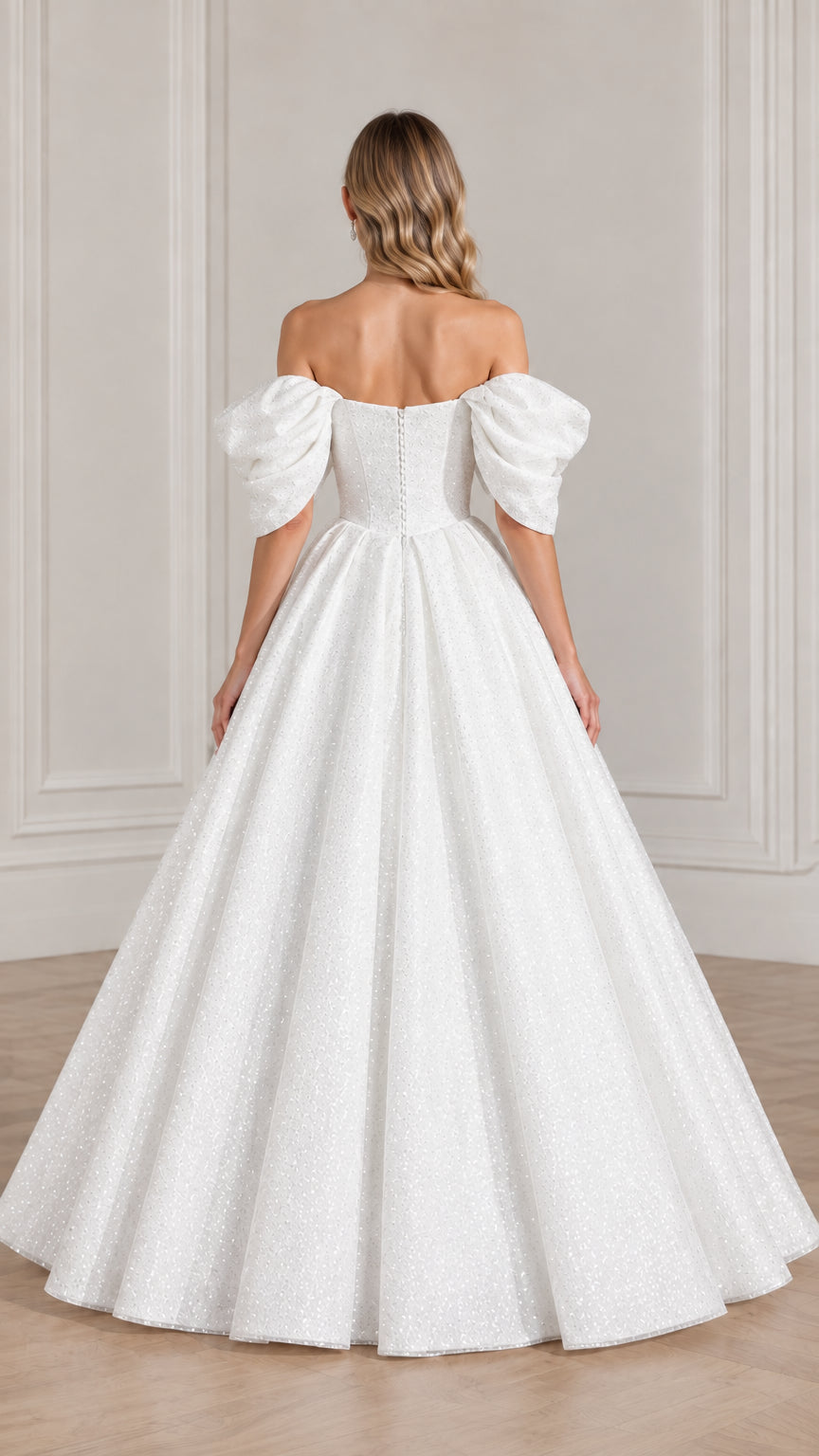 Back view of model showcasing the back closure and voluminous skirt of the white glitter gown