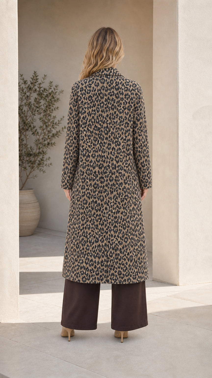 Back view of woman wearing Classic Tan longline leopard print coat