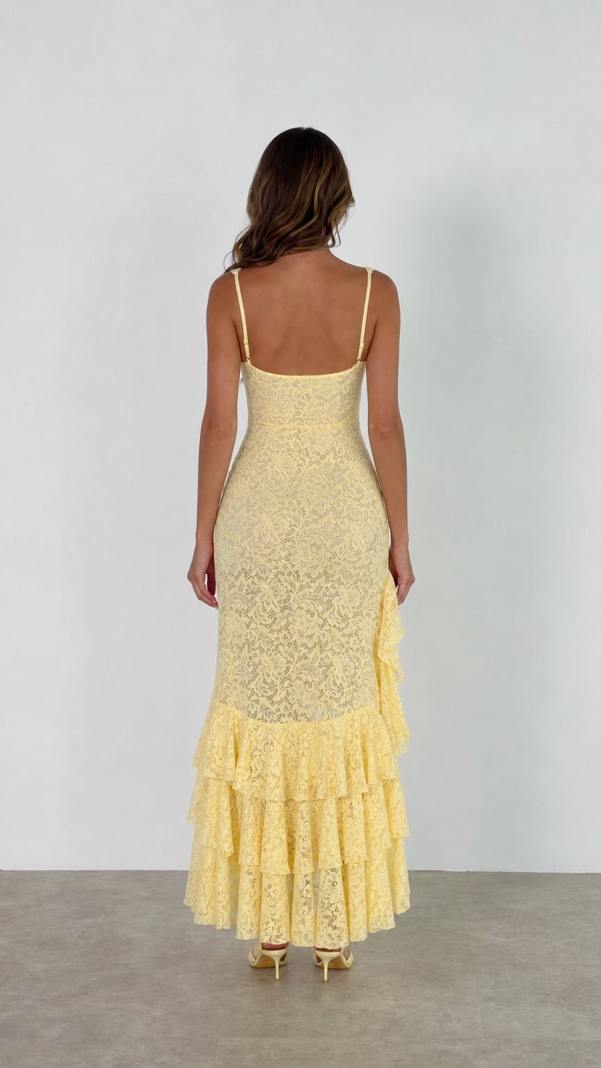 Back view of model wearing yellow floral lace maxi dress with scoop back