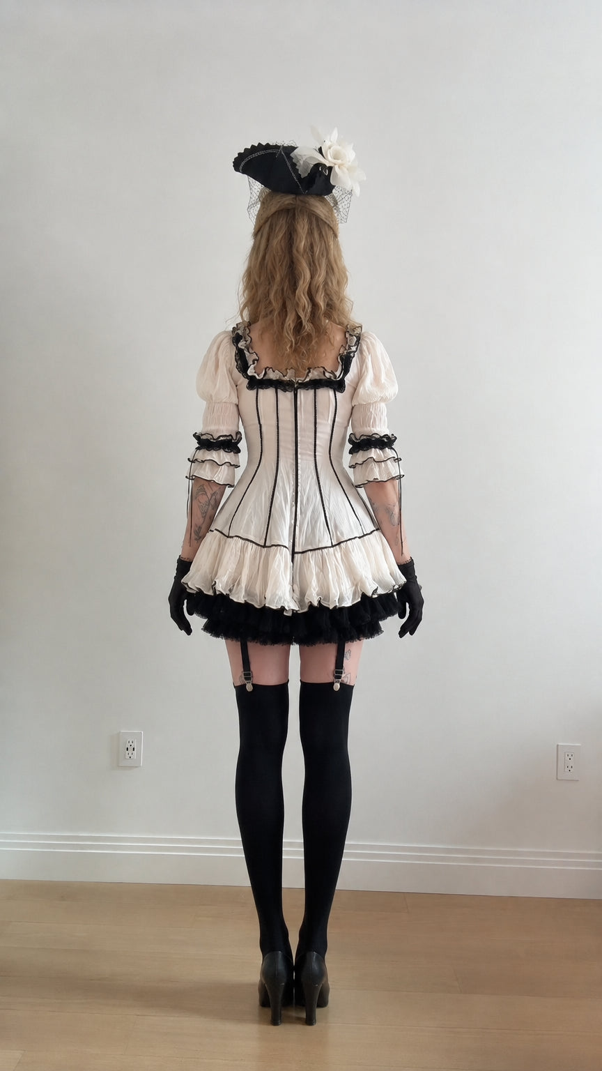 Back view of white gothic lolita mini dress with black trim details