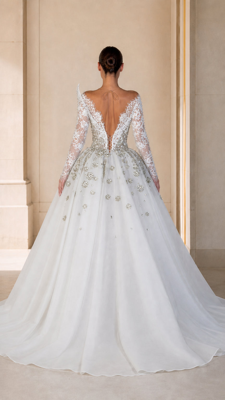 Back view of model in white beaded gown showing sheer illusion open back