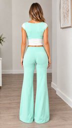 Back view of mint green cap sleeve top and matching high-rise flare pants