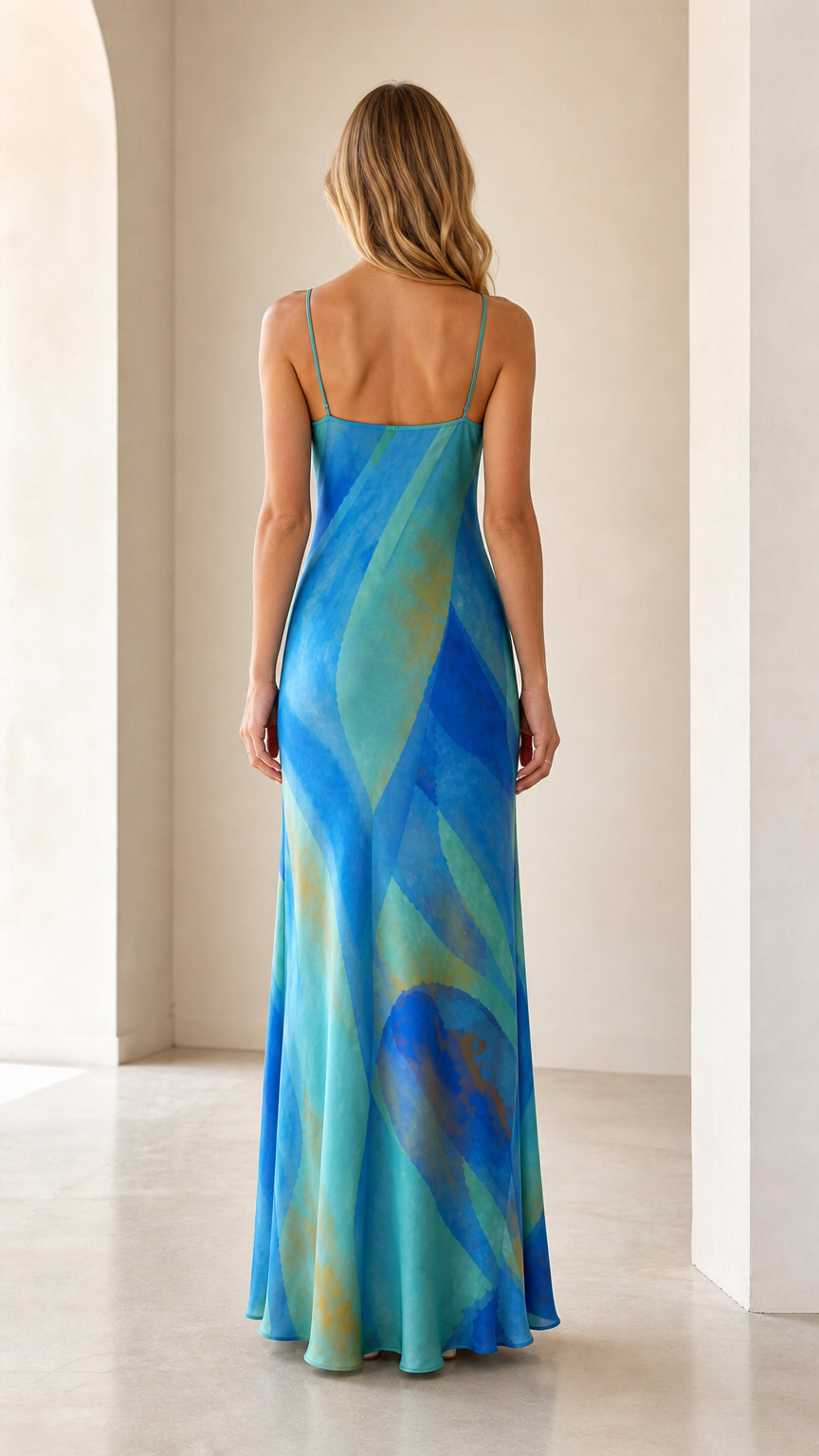 Back view of model in aqua blue spaghetti strap maxi slip dress