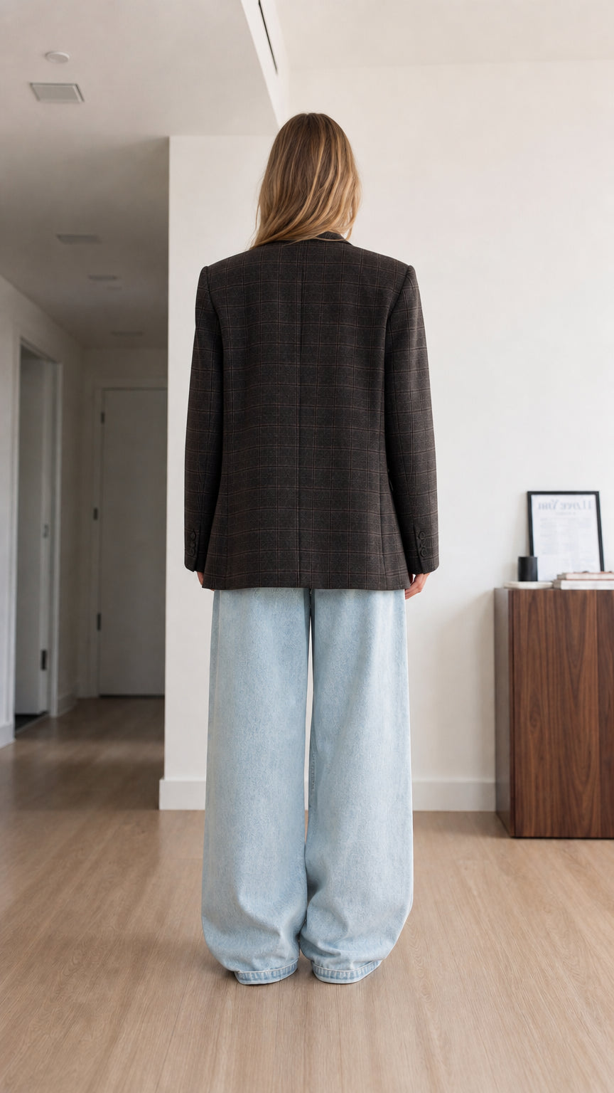 Back view of model wearing charcoal plaid single-breasted blazer