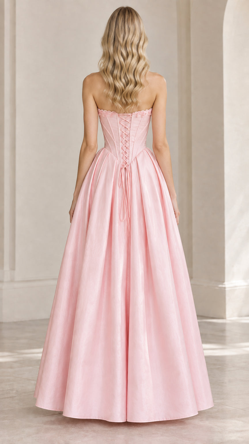 Back view of model showing lace-up corset back on pink formal gown