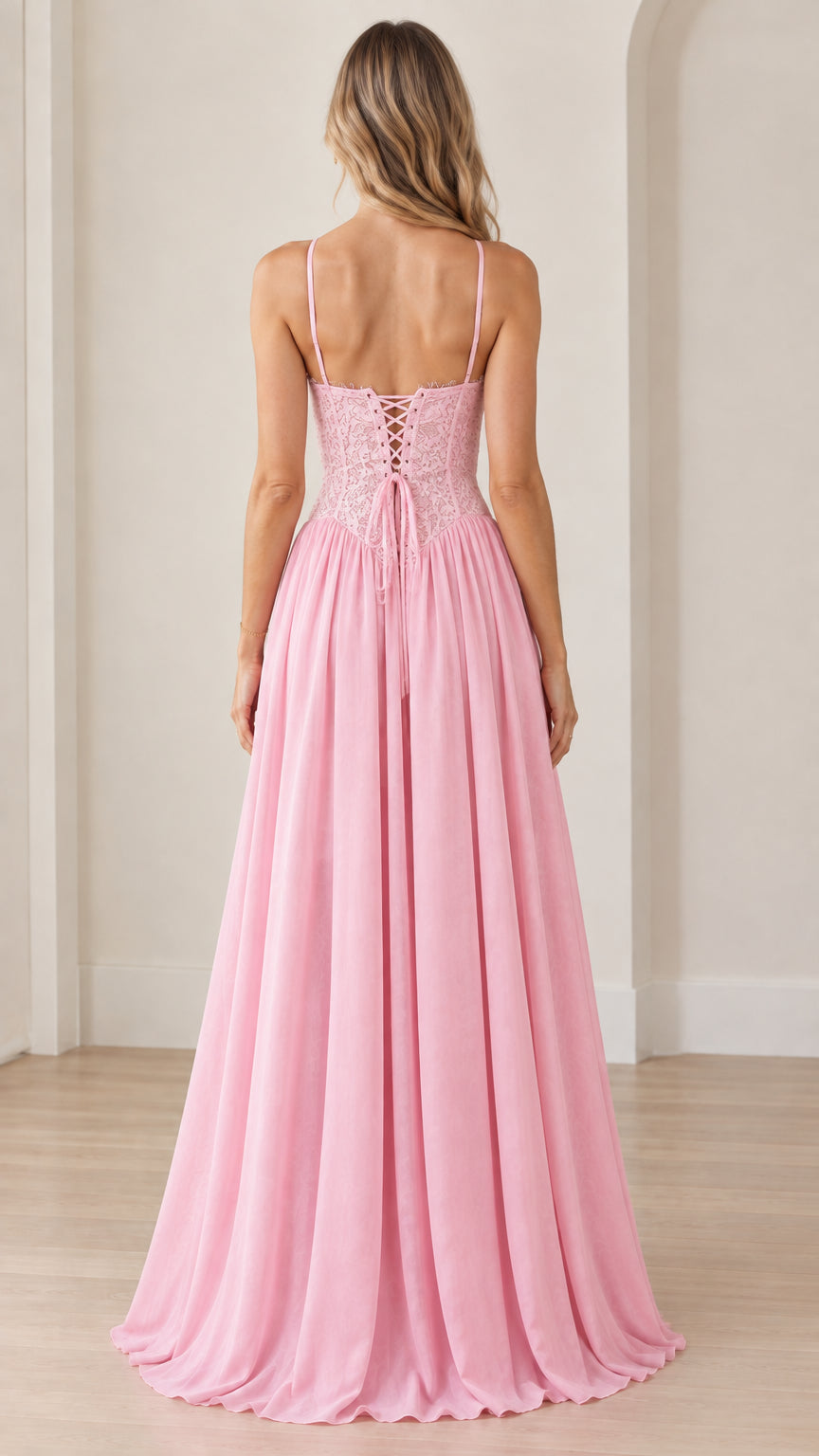 Back view of woman wearing pink maxi dress showing lace-up back detailing