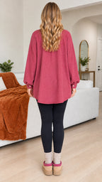 Back view of woman wearing tunic length berry pink ribbed shirt jacket