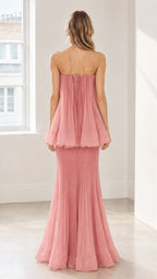 Back full-length view of model in dusty pink strapless pleated evening gown