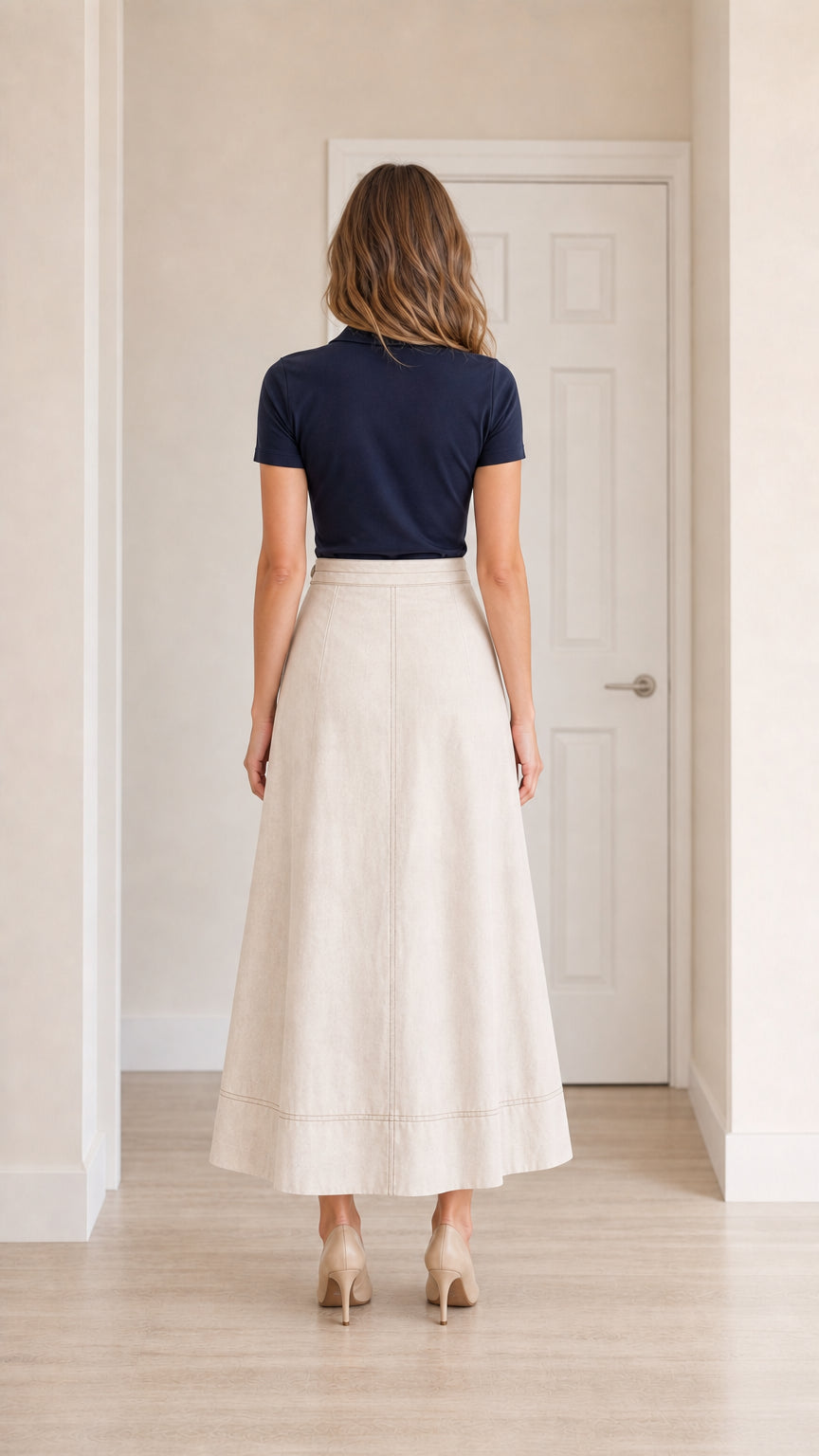 Back view of model wearing beige A-line maxi skirt