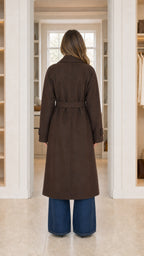 Back view of chocolate brown tailored long belted overcoat on model
