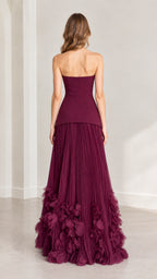 Back view of model wearing burgundy strapless gown with back zipper closure