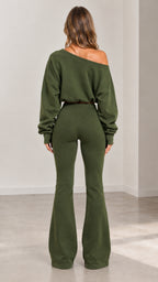 Back full-body view of off-shoulder cropped sweater and flare trousers set in army green