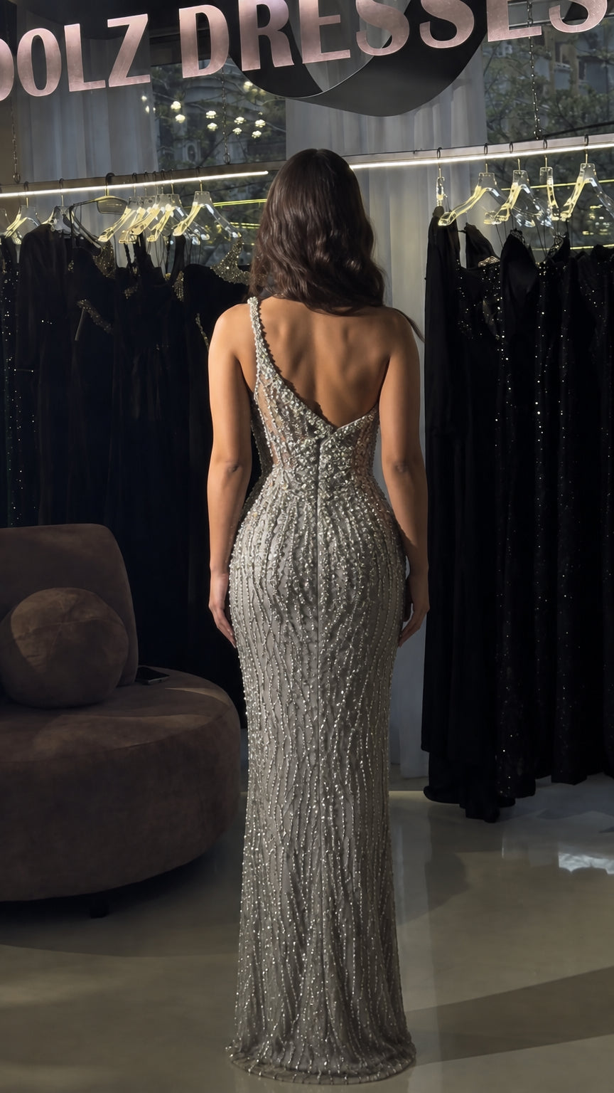 Back view of model in silver beaded evening gown showing low back cut