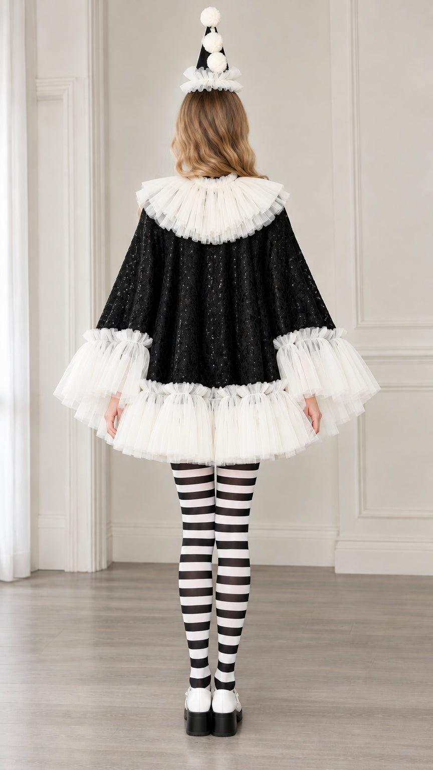 Rear view of model wearing black sequin Pierrot clown cape costume showing the voluminous tulle ruffled hemline