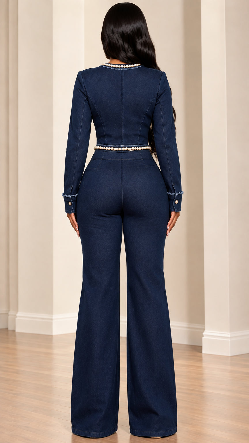 Back view of model in dark blue cropped denim jacket and high-waisted flare pants