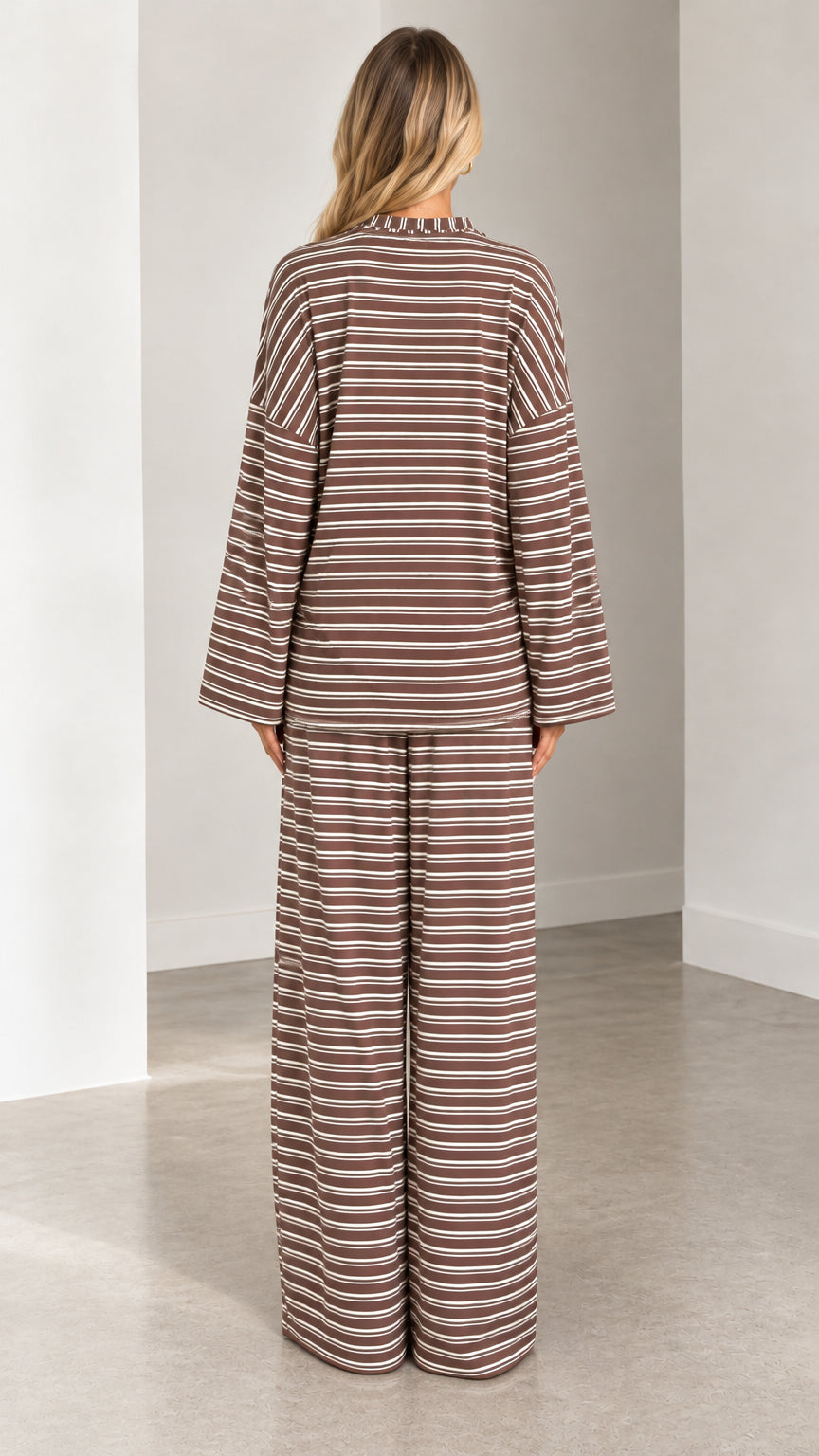 Back full-length view of model wearing the relaxed-fit brown striped loungewear set
