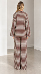 Back full-length view of model wearing the relaxed-fit brown striped loungewear set