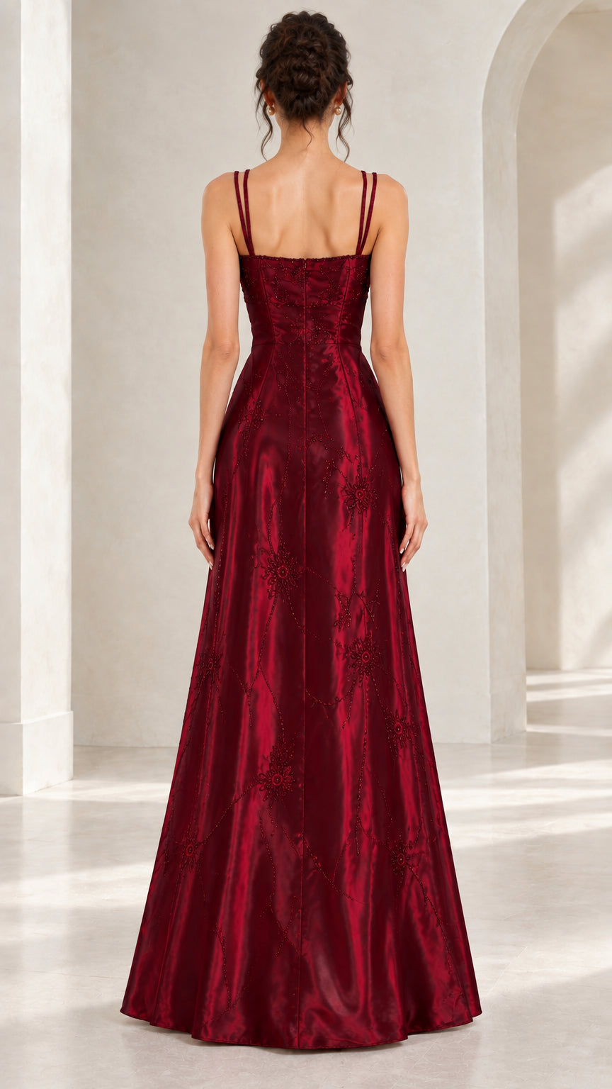 Back view of woman wearing burgundy double strap satin A-line maxi gown
