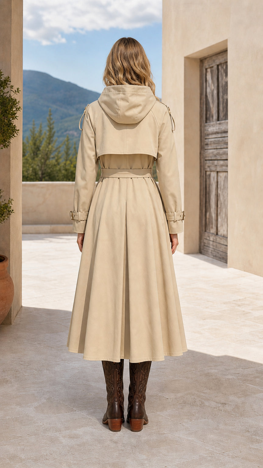 Back view of beige hooded trench coat with storm flap detailing
