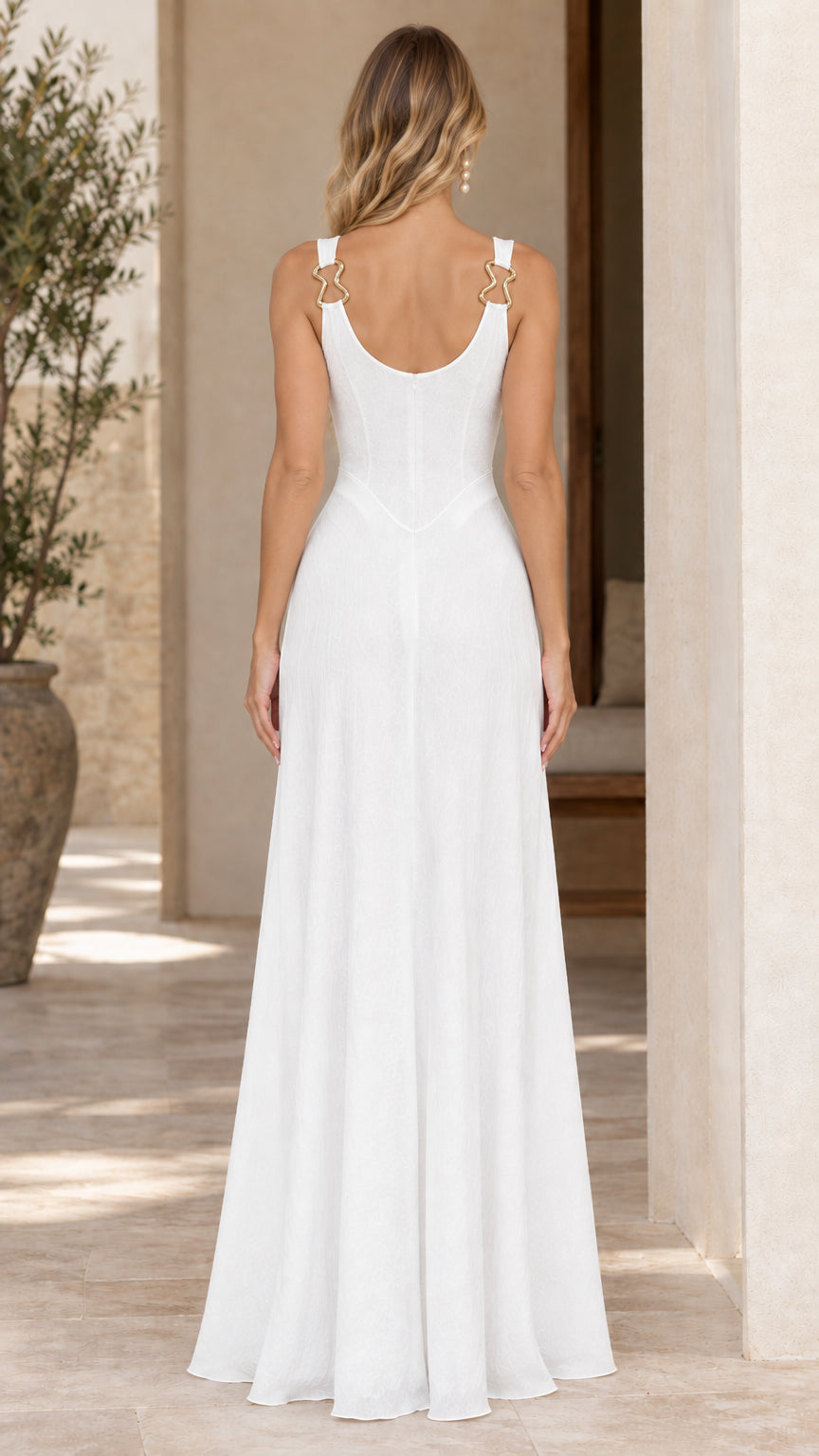Back view of woman in white sleeveless maxi dress showing scoop back and concealed zipper