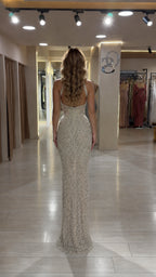 Back view of woman wearing open-back Champagne embellished maxi dress